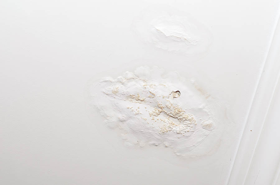 roof leakage with deforming white ceiling